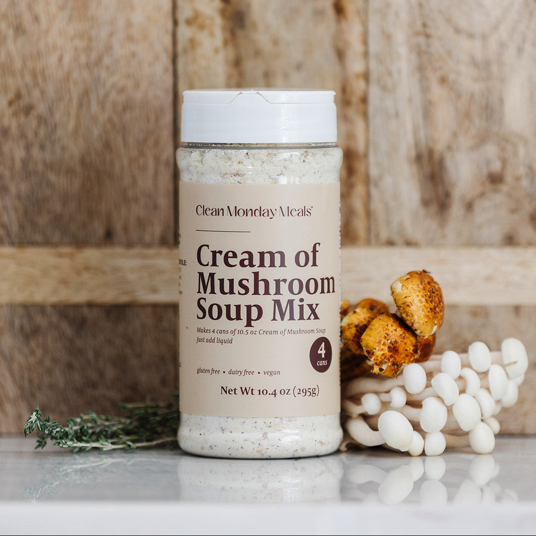 Cream of Mushroom Soup Mix container with dried mushrooms and herbs on a wooden background