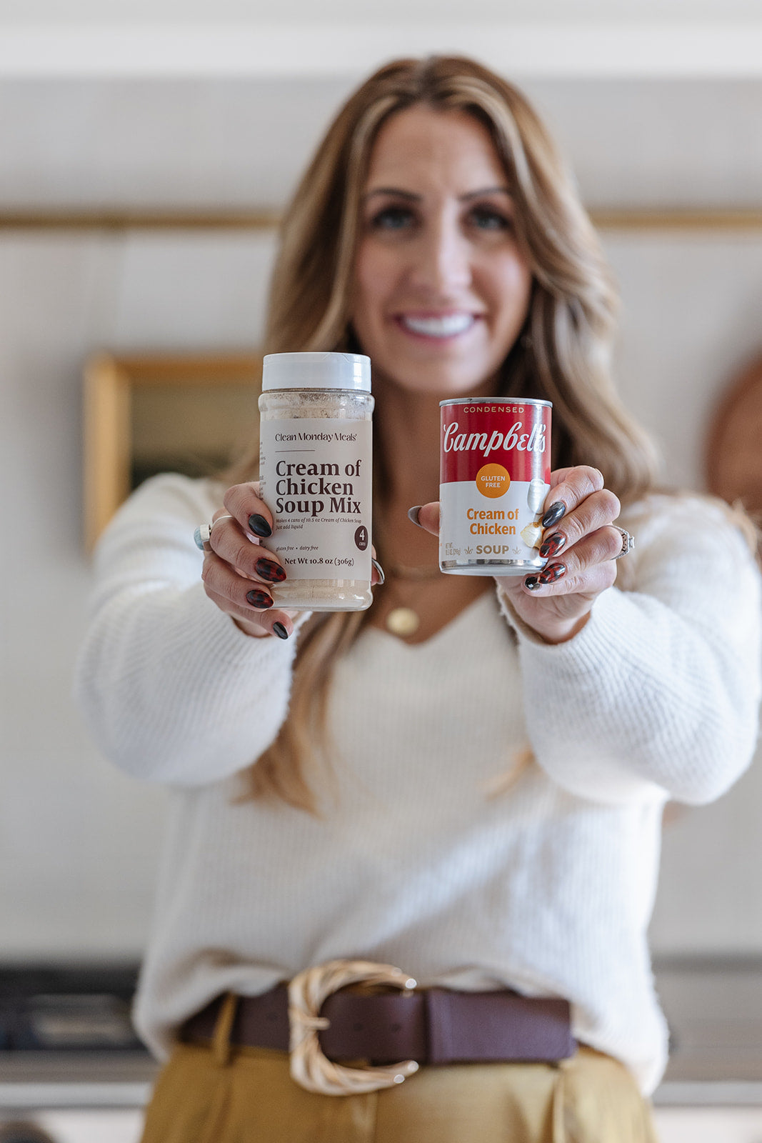 Janae Cox holding a can of Campbell's Cream of Chicken Soup Mix and a container of Campbell's Cream of Chicken Soup Mix in a kitchen setting.