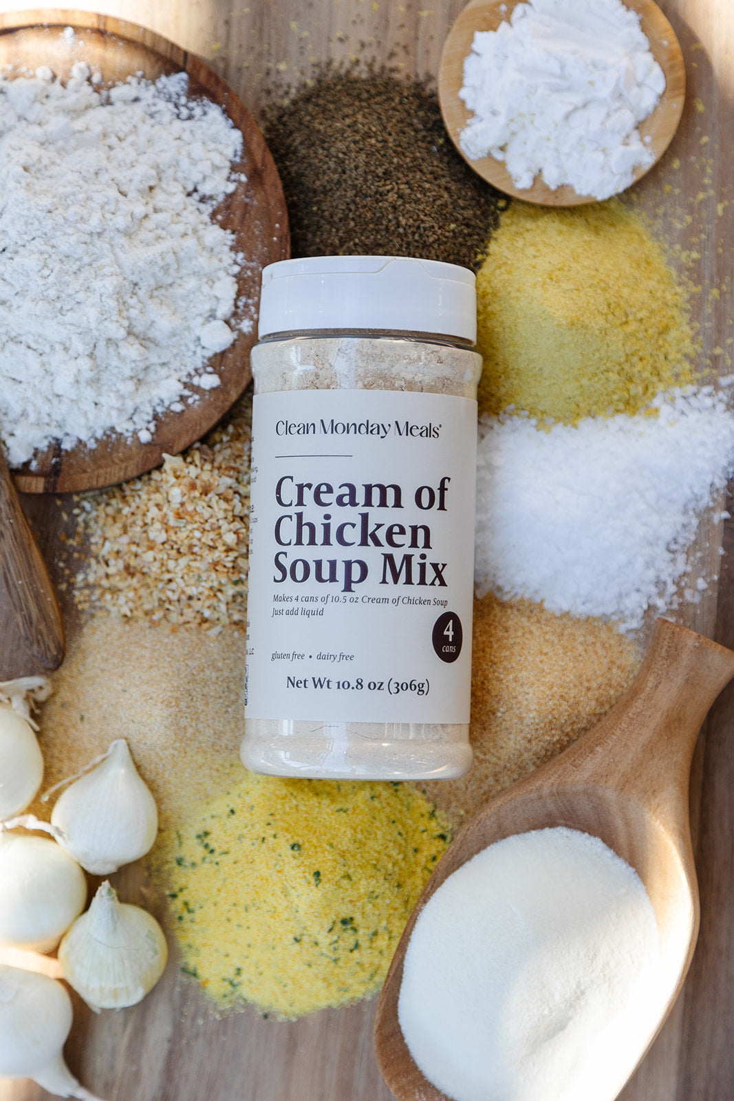 Container of 'Cream of Chicken Soup Mix' surrounded by various ingredients on a wooden surface