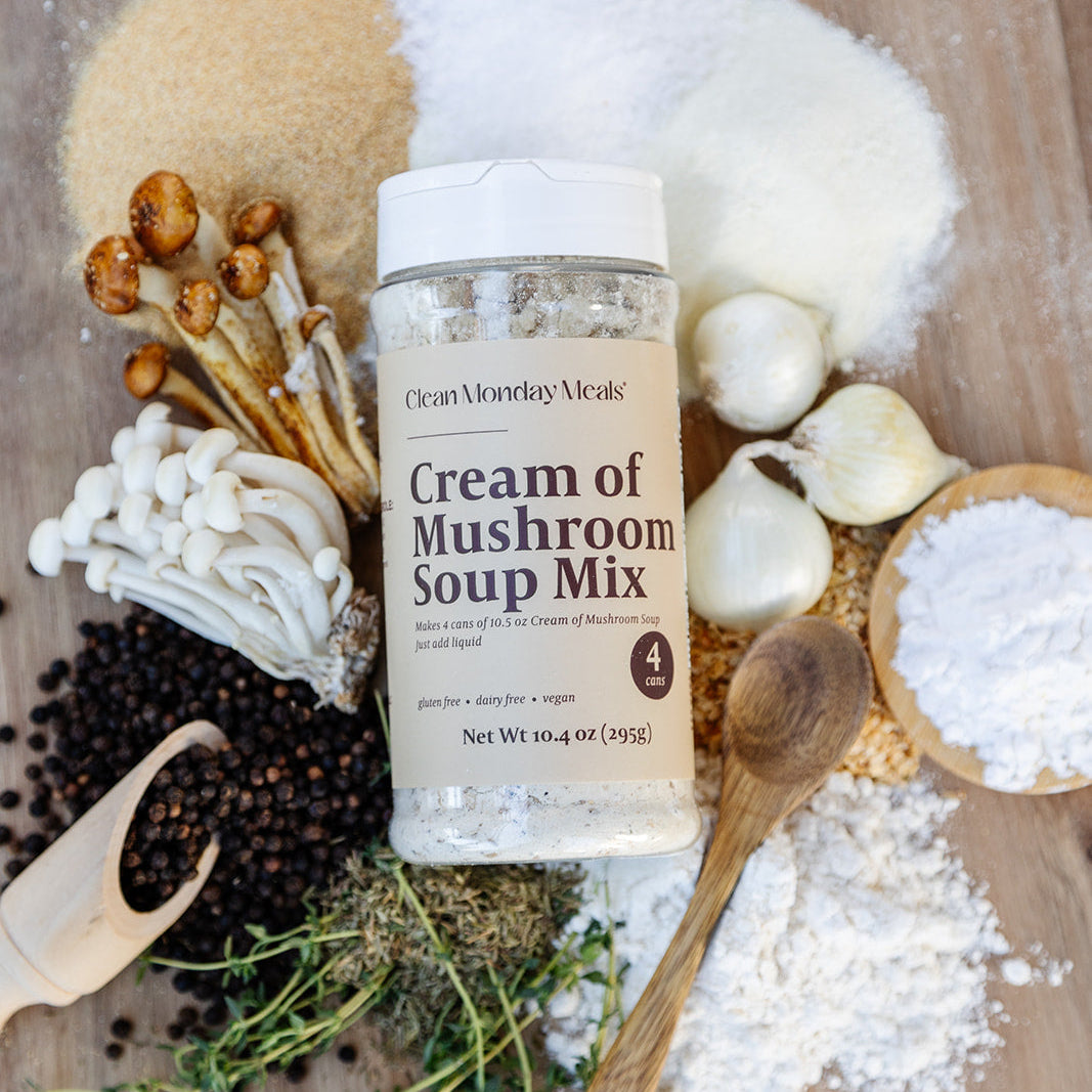 Cream of Mushroom Soup Mix bottle surrounded by ingredients on a wooden surface