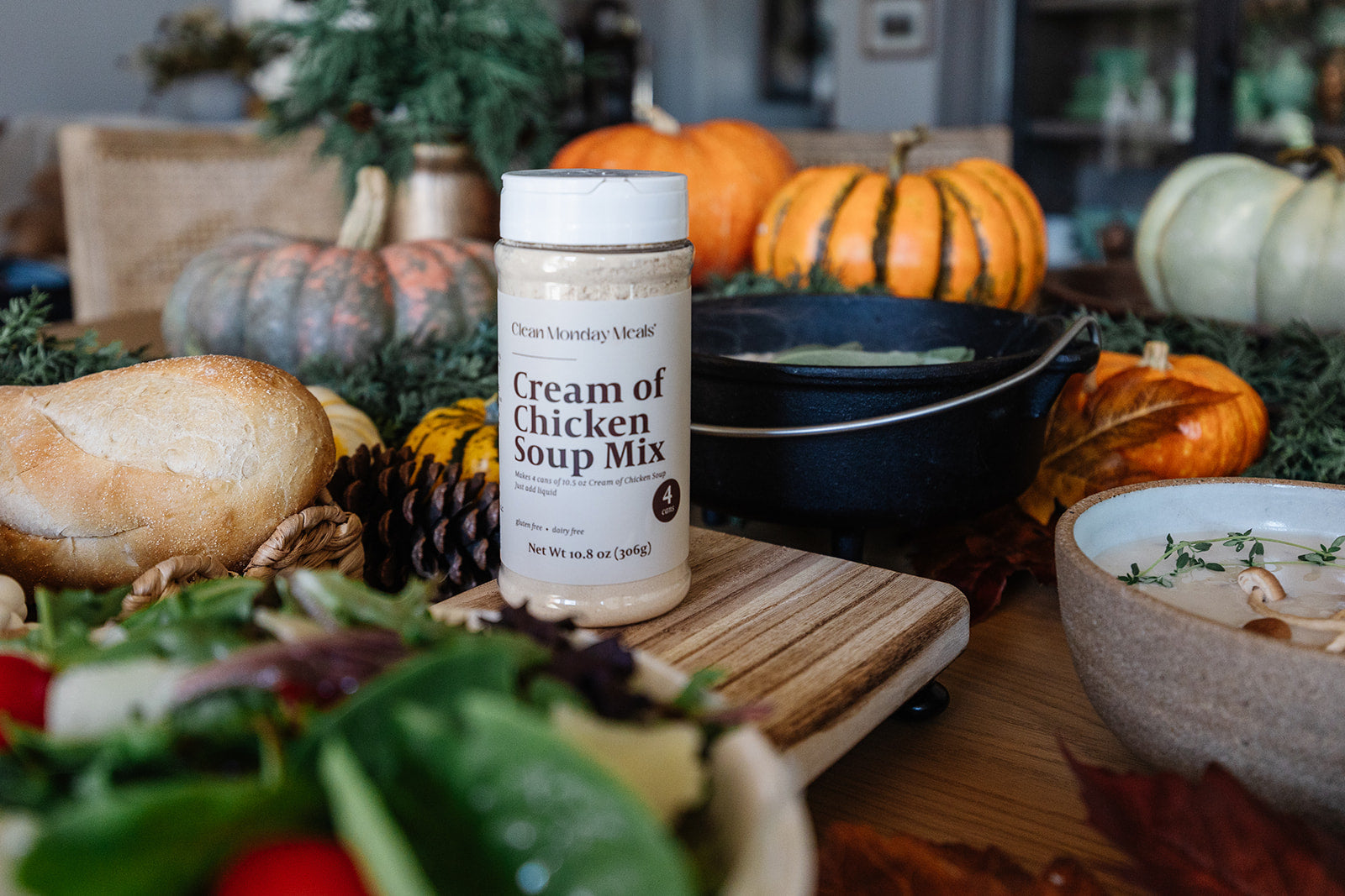 Container of Cream of Chicken Soup Mix on a table with pumpkins and other fall decorations.