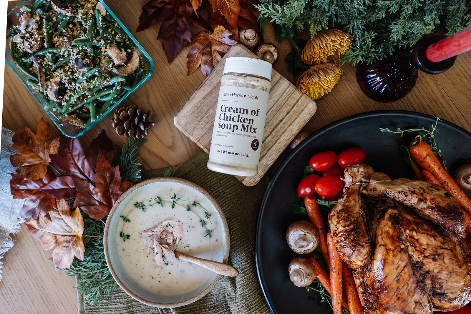 Table setting with a bowl of cream of chicken soup, roasted vegetables, and a bottle of cream of chicken soup mix.