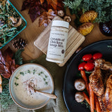 Table setting with a bowl of cream of chicken soup, roasted vegetables, and a bottle of cream of chicken soup mix.