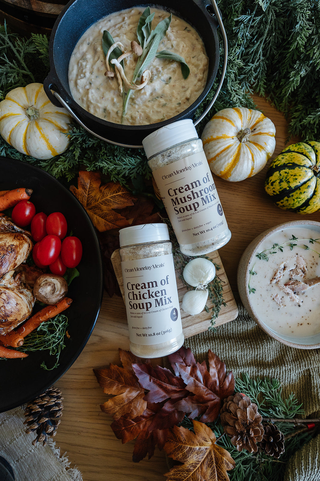 Cream of Chicken Soup Mix bottles on a wooden board with pumpkins and vegetables.