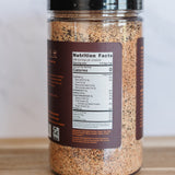 Spice jar with a nutrition label on a wooden surface