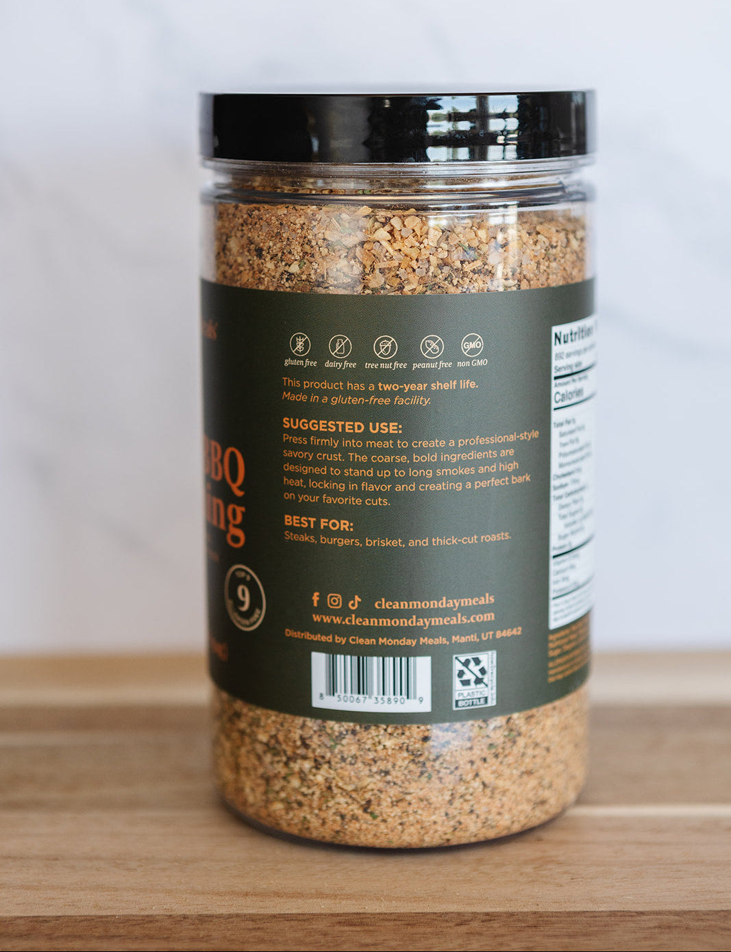 Spice jar with a label on a wooden surface and white background