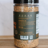Spice jar with a label on a wooden surface and white background