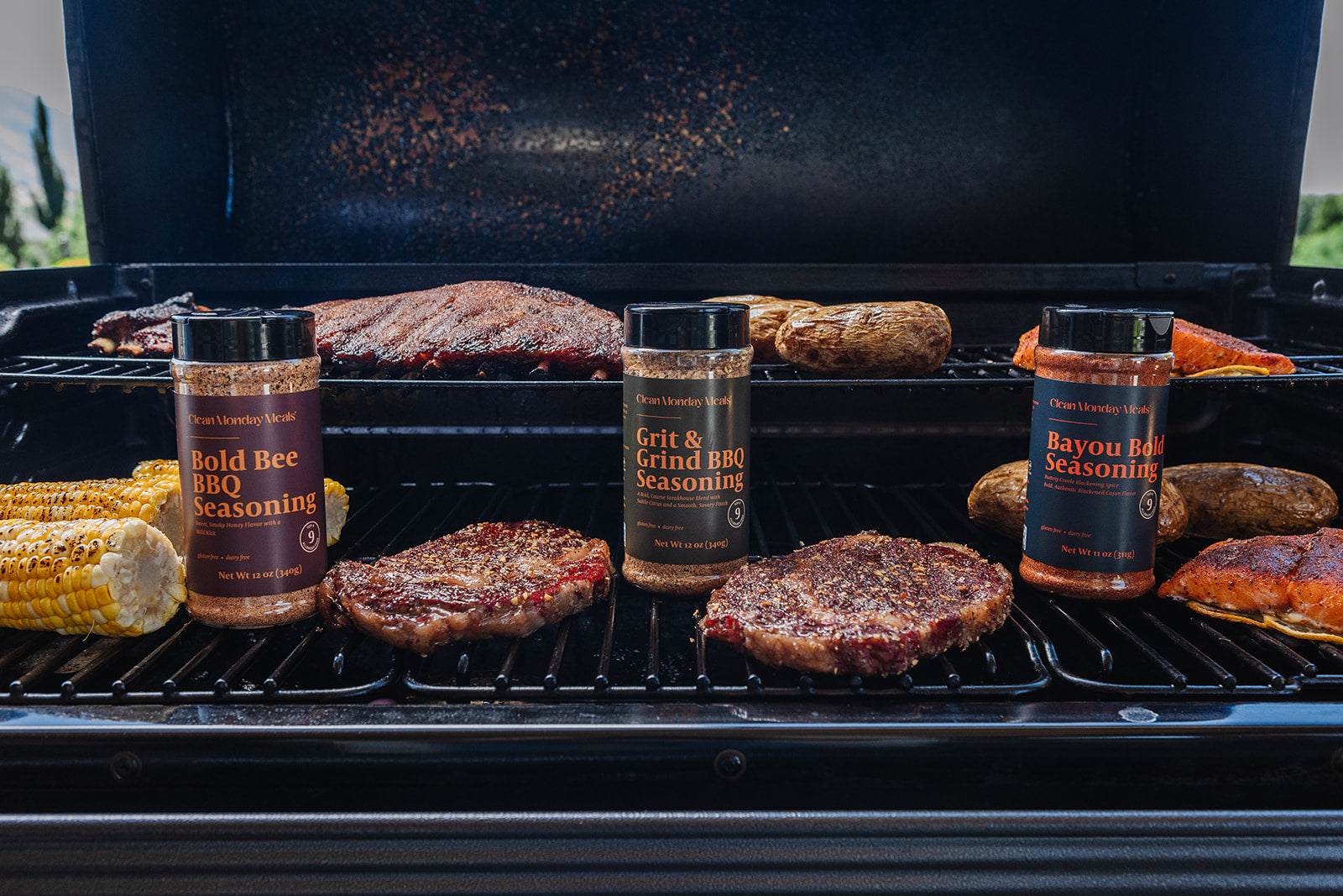 Grill with burgers and seasoning bottles on a barbecue