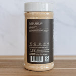 A jar of Diamond's Gourmet Classic Beef Dip, showing the back label, placed on a wooden surface against a light marble background.
