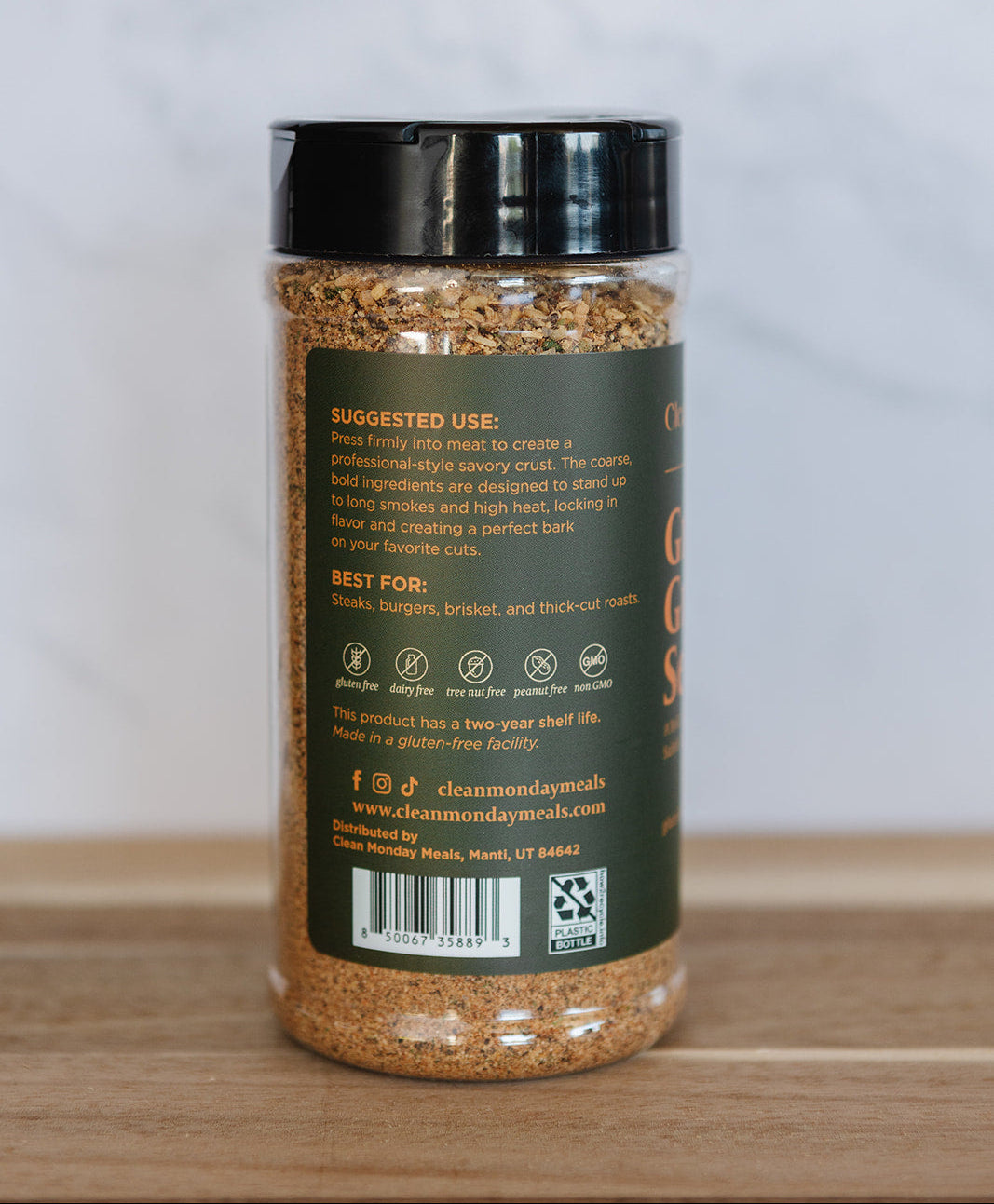 Spice jar with black lid and label on a wooden surface