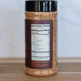 Spice jar with a label on a wooden surface and light gray background