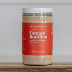 Jar of Clean Monday Meals Tomato Bouillon on a wooden surface and white background. 