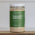 Jar of Vegetable Bouillon with a green label on a wooden surface.