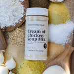 Container of 'Cream of Chicken Soup Mix' surrounded by various ingredients on a wooden surface
