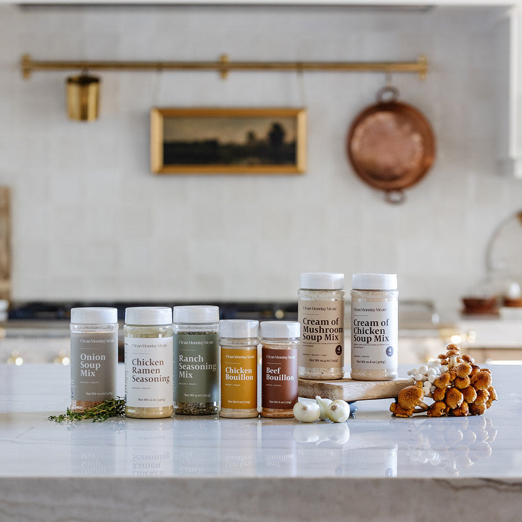 Collection of spice jars on a kitchen counter with a neutral background