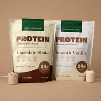 Two protein shake packages, one chocolate shake and one smooth vanilla, on a beige background.