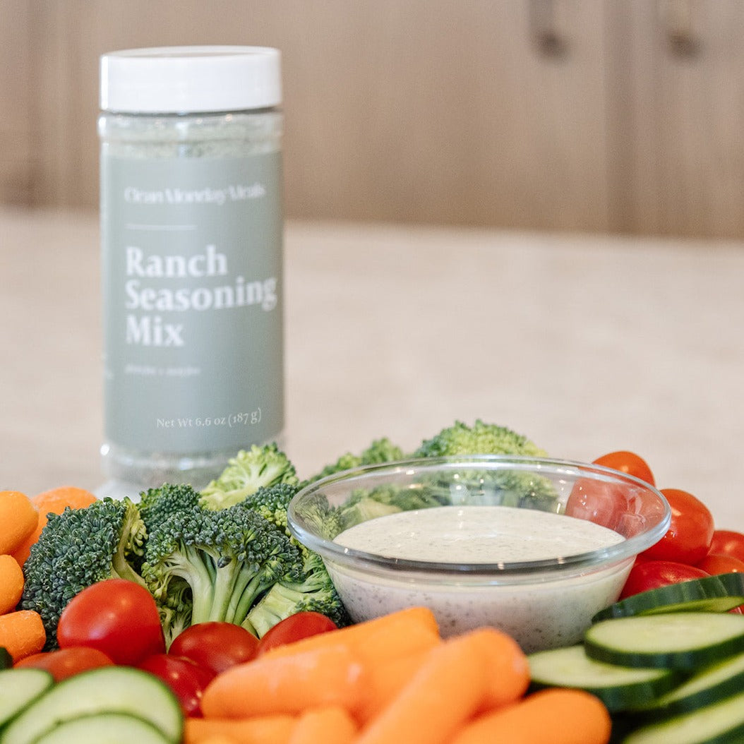 Clean Mondy Meals ranch seasoning sitting next to a vegtable tray. 