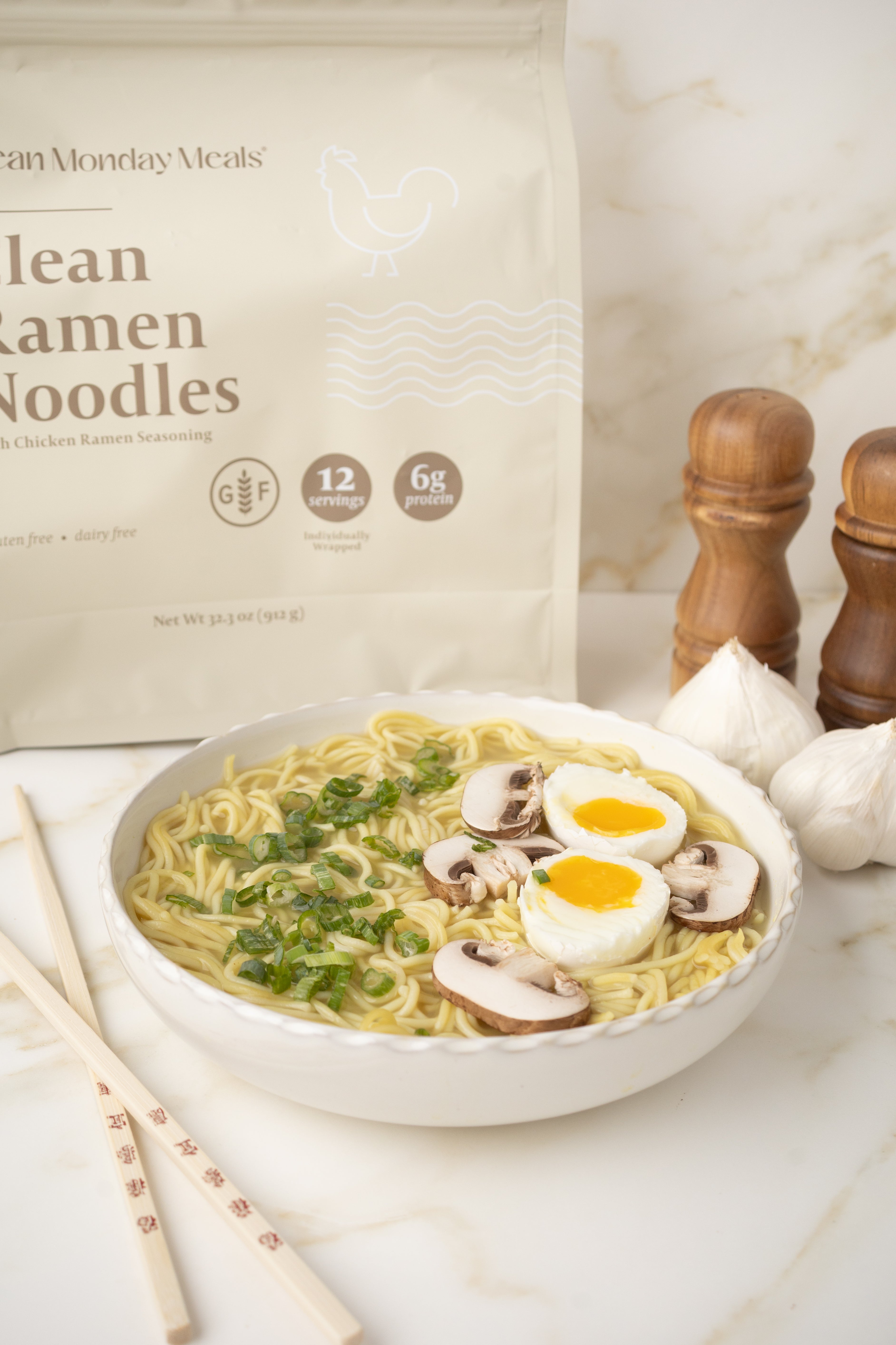 Bowl of ramen noodles with a package of clean ramen noodles in the background.