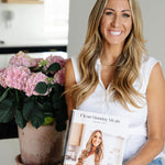 Janae Cox holding her cookbook. 