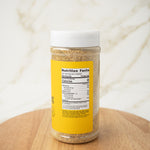 Spice jar with a nutrition facts label on a wooden surface