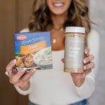 Janae Cox holding a box of lipton onion soup mix and a Clean Monday Meals onion soup mix in her other hand. 